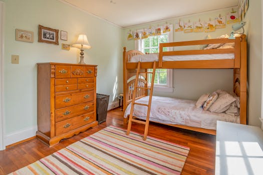 Warm and inviting children's bedroom featuring a classic wooden bunk bed and colorful decor.