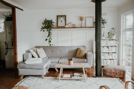 Bright and cozy living room with Scandinavian design and modern home decor, featuring a sofa and plants.